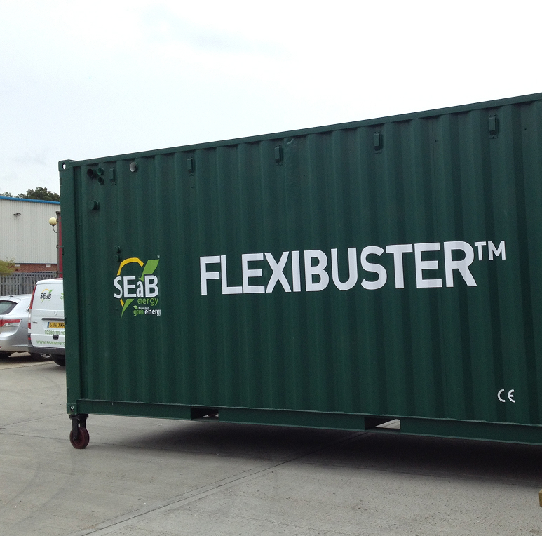 Flexibuster™, a containerised Anaerobic Digestion unit created by SEaB Energy, on a site in a car park.